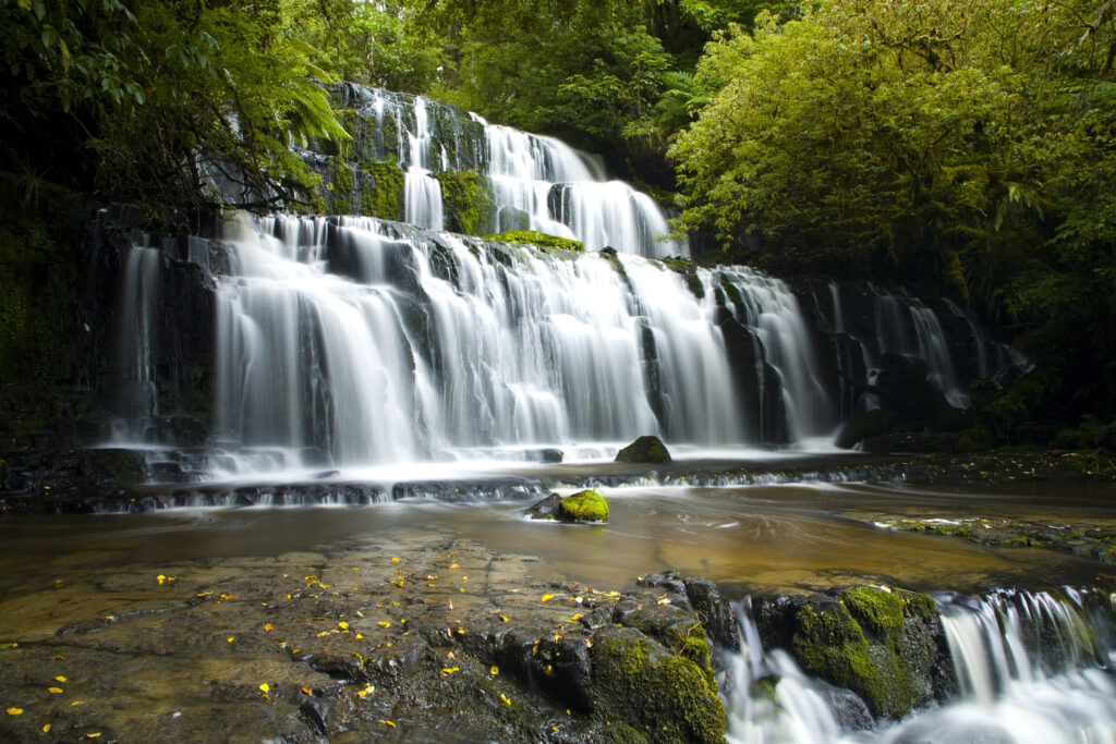 New Zealand, Southland, The Catlins. Purakaunui Falls surrounded by native woodland and bush in the Catlins Forest Park.