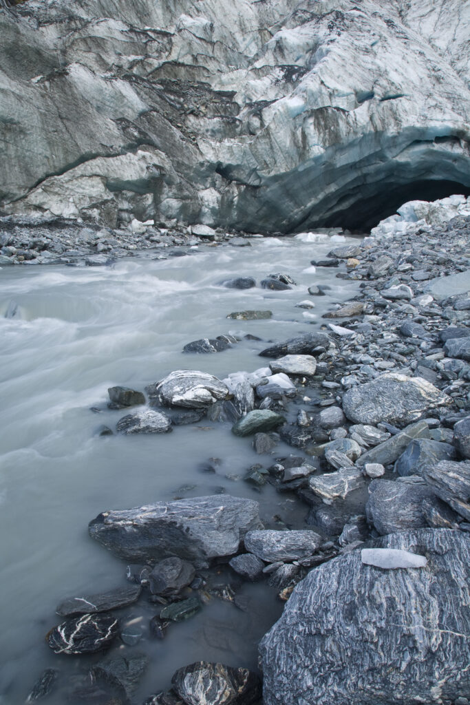 NEW ZEALAND, Westland, Westland National Park. Glacial river and glacial deposited rocks downstream of the Franz Josef Glacier.