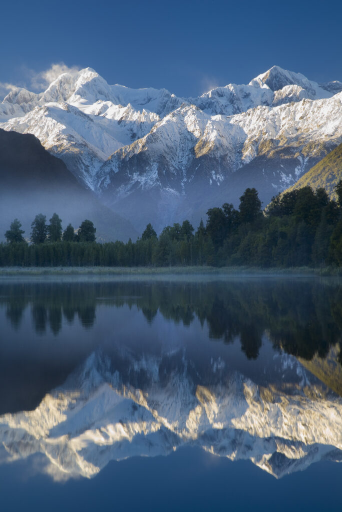 New Zealand, Westland, Westland National Park. Mt Cook and Mt Tasman reflected in the still waters of Lake Matheson.