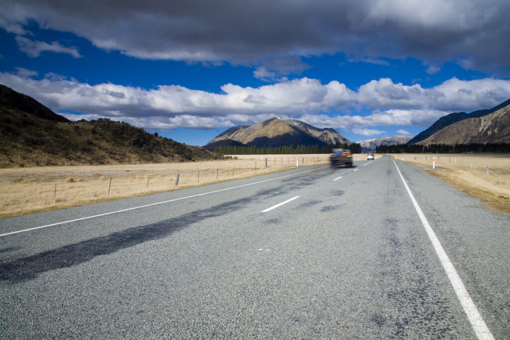 New Zealand, Canterbury, Highway 73. Traffic on Highway 73, looking towards the Craigieburn mountain range.