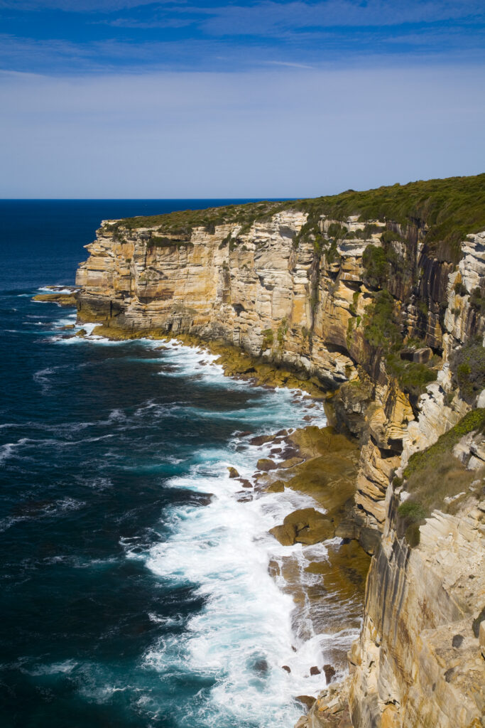 Australia, New South Wales, Royal National Park. Sandstone cliifs overlooking the Pacific Ocean viewed from the Royal National Park Coastal Track.