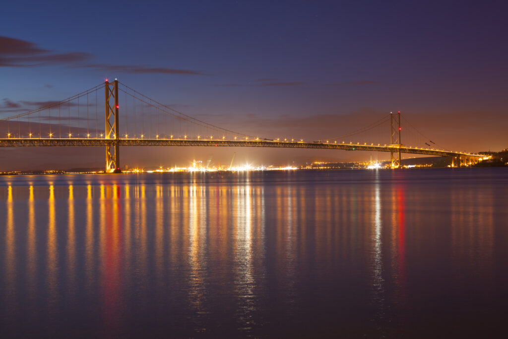 Scotland, Edinburgh, Forth Bridge. Forth Road Bridge connecting Scotland's capital city, Edinburgh, with Fife, leaving the Lothians at Dalmeny and arriving in Fife at North Queensferry.