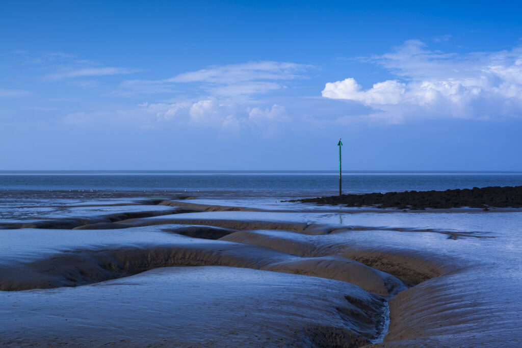 England, Lancashire, Morecambe. Mud flats at low tide near the seaside resort of Morecambe located on Morecambe Bay.