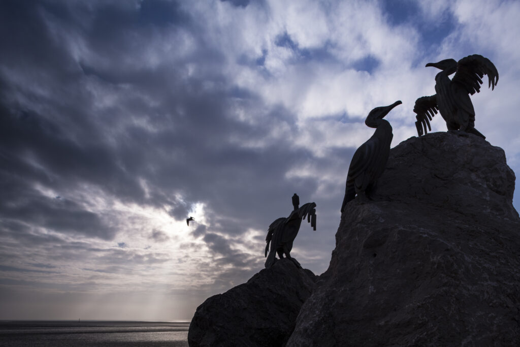 England, Lancashire, Morecambe. Cormorant statues on Morecambe's sea front promenade as part of the Tern regeneration project.