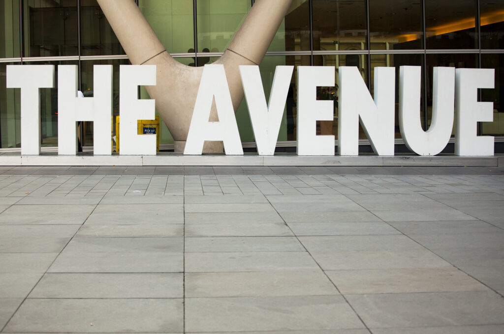 England, Greater Manchester, Manchester. Modern sign and square forming part of the Avenue complex in the Springfields Area.