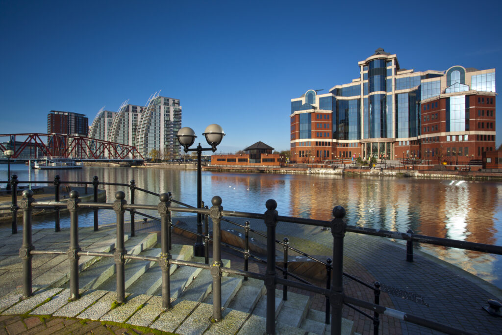 England, Greater Manchester, Salford Quays. NV apartments, Detroit Bridge and Victoria Harbour building located along the Manchester Ship Canal in Salford.