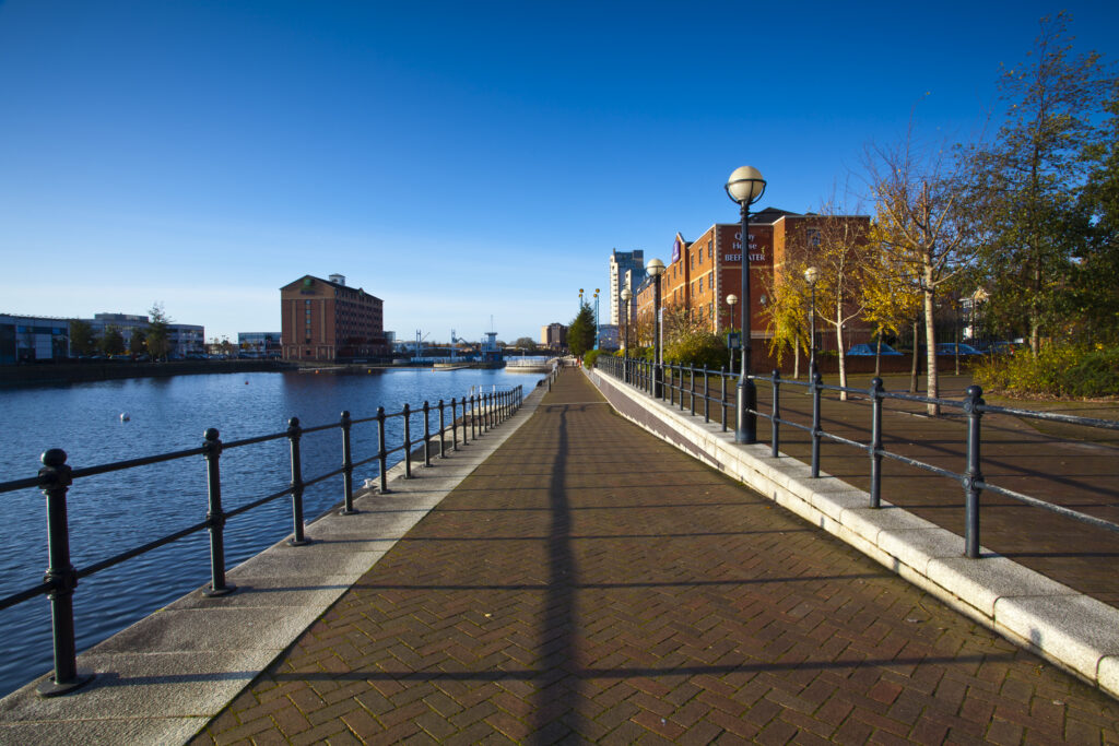 England, Greater Manchester, Salford Quays. Walkway alongside Ontario Basin located on the Salford Quays in the City of Salford in Greater Manchester.