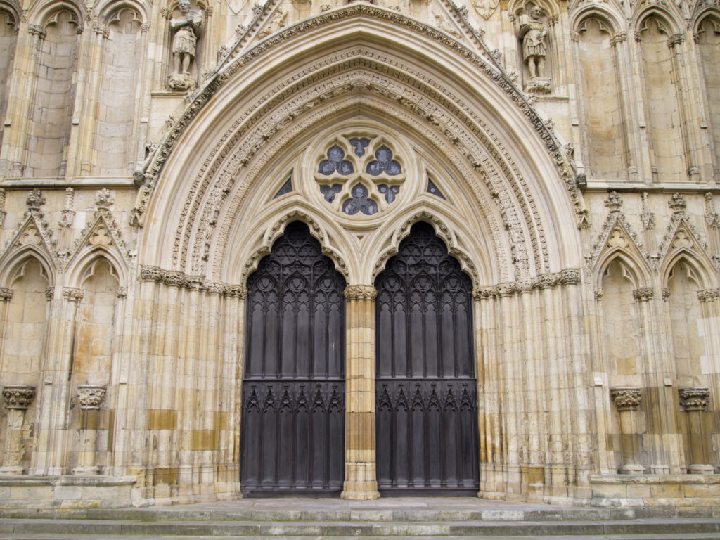 England, North Yorkshire, York City. Grand door and arch on the West Front entrance of York Minster.