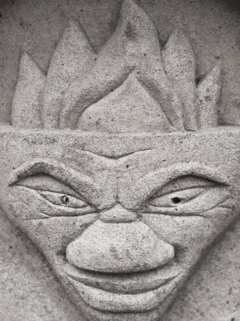 England, North Yorkshire, York City. Gargoyle on bench in Dean's Park in the grounds of York Minster cathedral.