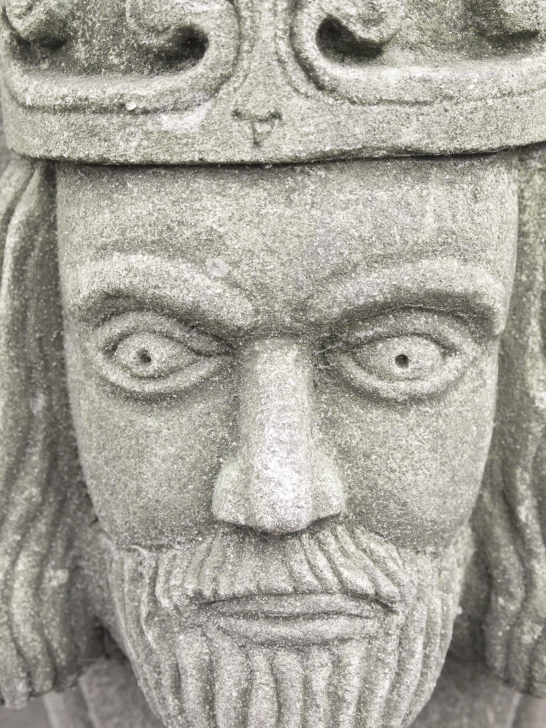 England, North Yorkshire, York City. Gargoyle on bench in Dean's Park in the grounds of York Minster cathedral.