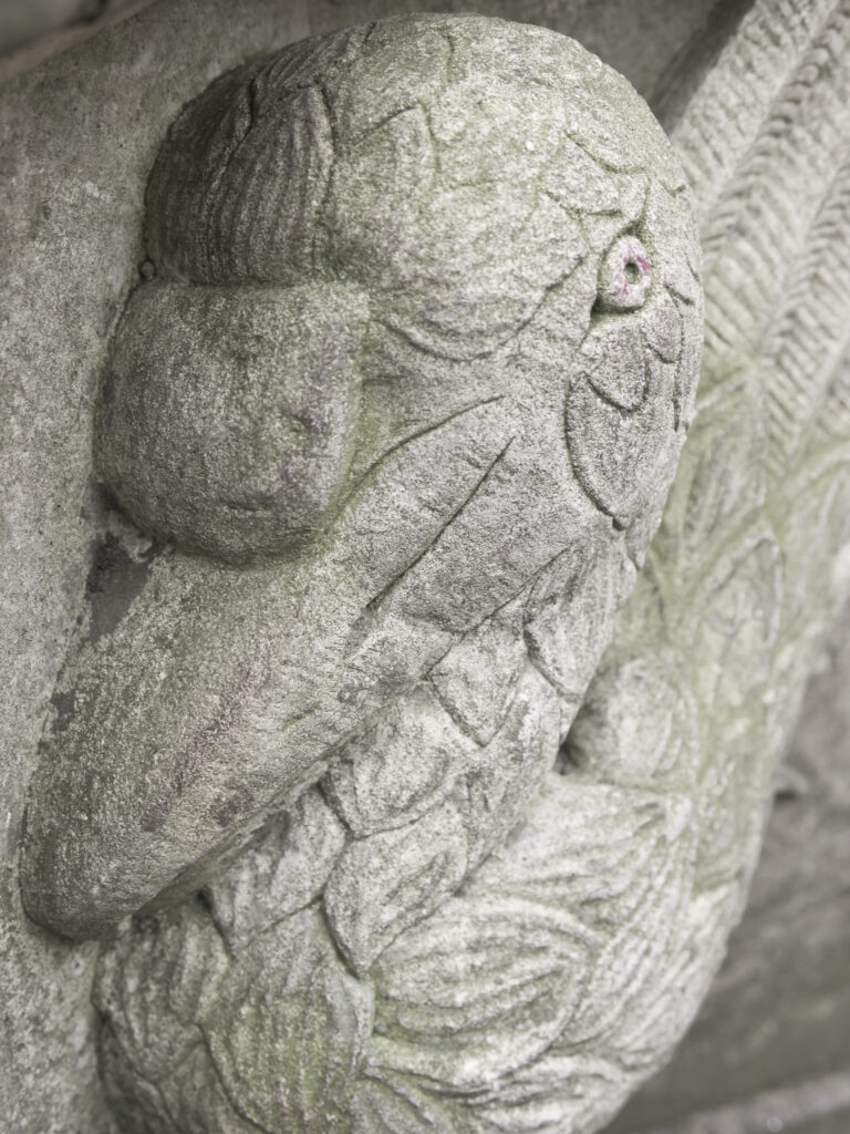 England, North Yorkshire, York City. Gargoyle on bench in Dean's Park in the grounds of York Minster cathedral.
