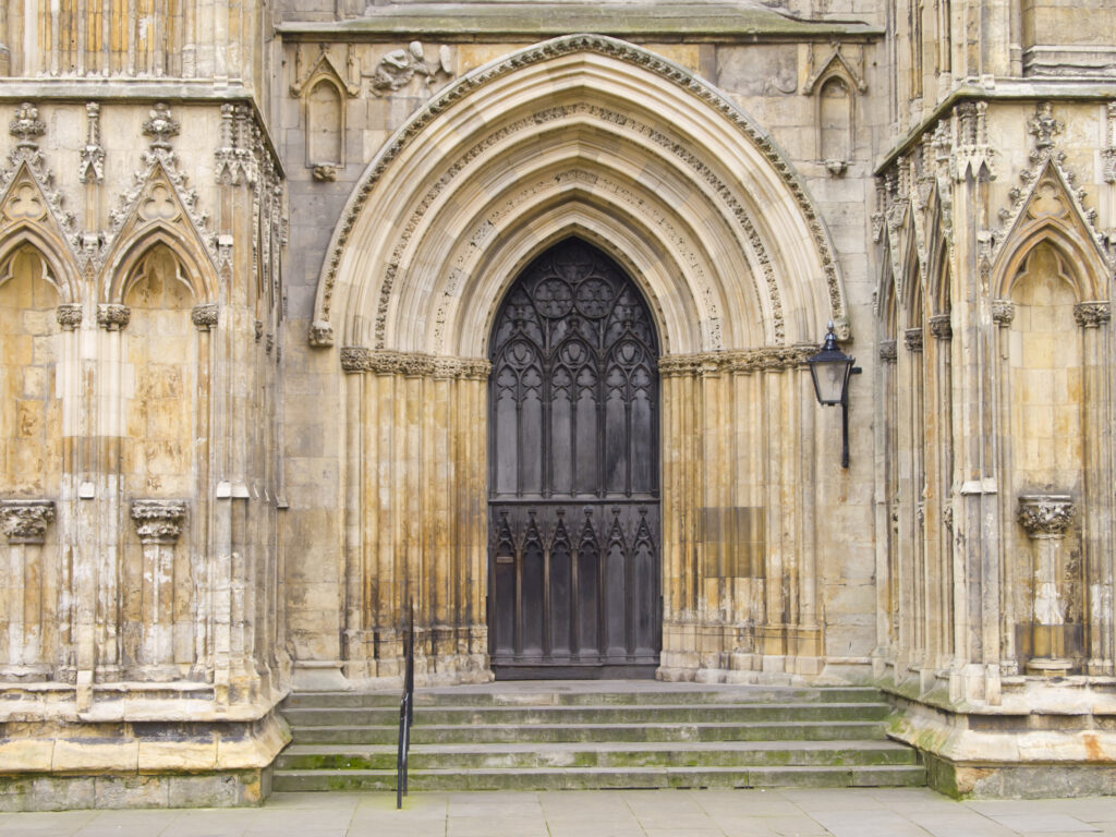 England, North Yorkshire, York City. Grand door and arch on the West Front entrance of York Minster.