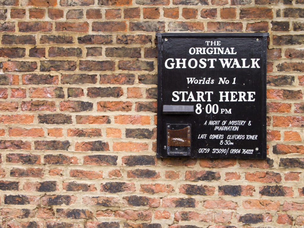 England, North Yorkshire, York City. Ghost Walk starting point sign on a wall near the River Ouse.