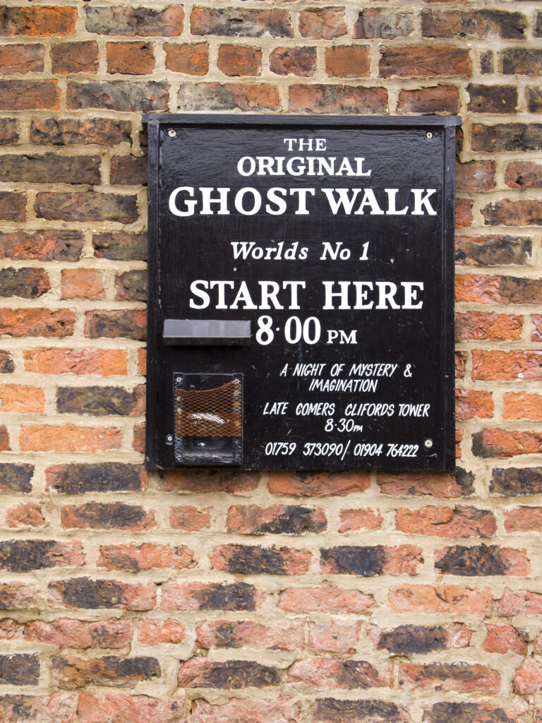 England, North Yorkshire, York City. Ghost Walk starting point sign on a wall near the River Ouse.