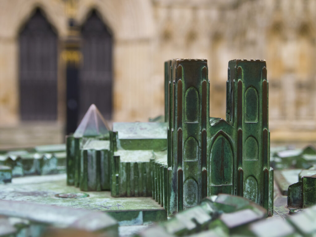 England, North Yorkshire, York City. Replica model of the York Minster with the actual Cathedral in the distance.