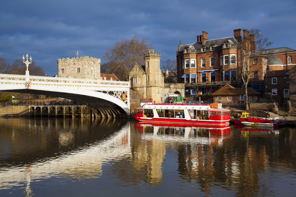 England, North Yorkshire, York City. York city river cruise boats moored on the River Ouse.