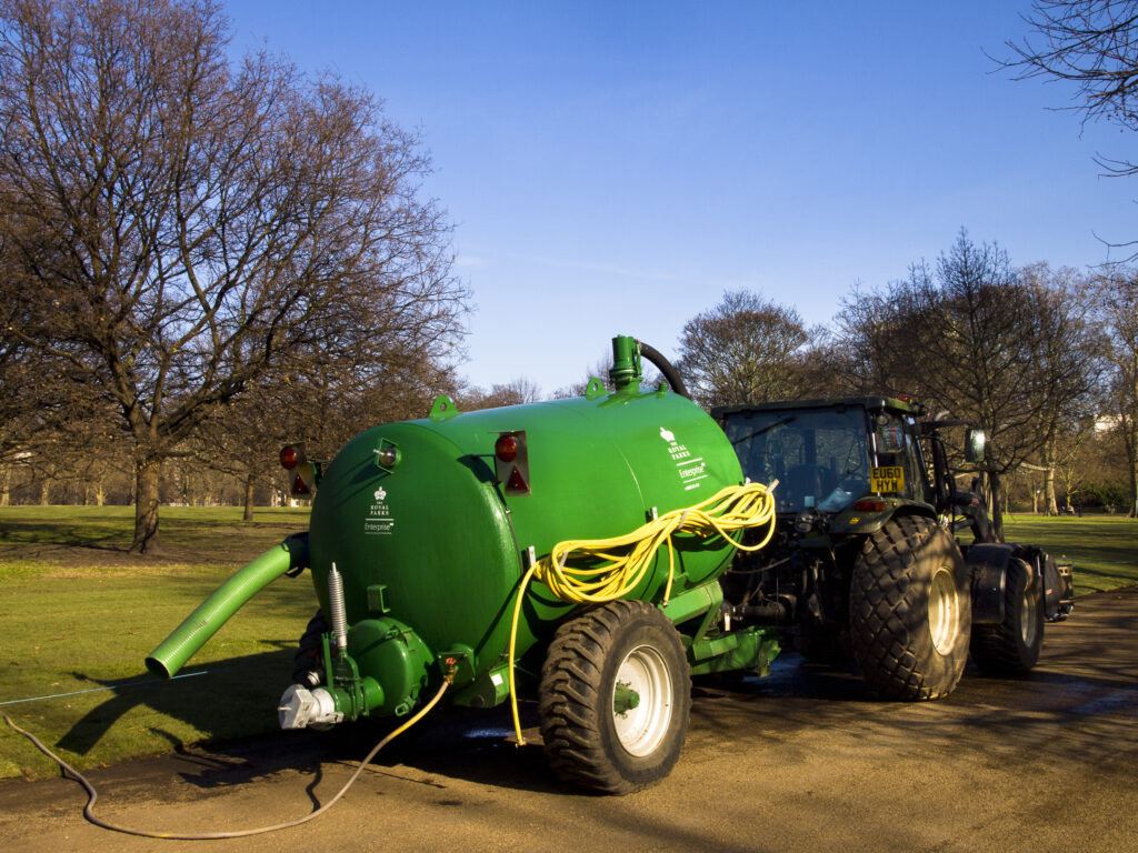 England, London, Hyde Park. Tractor for watering grass in Hyde Park, a popular green space near the city center of London.