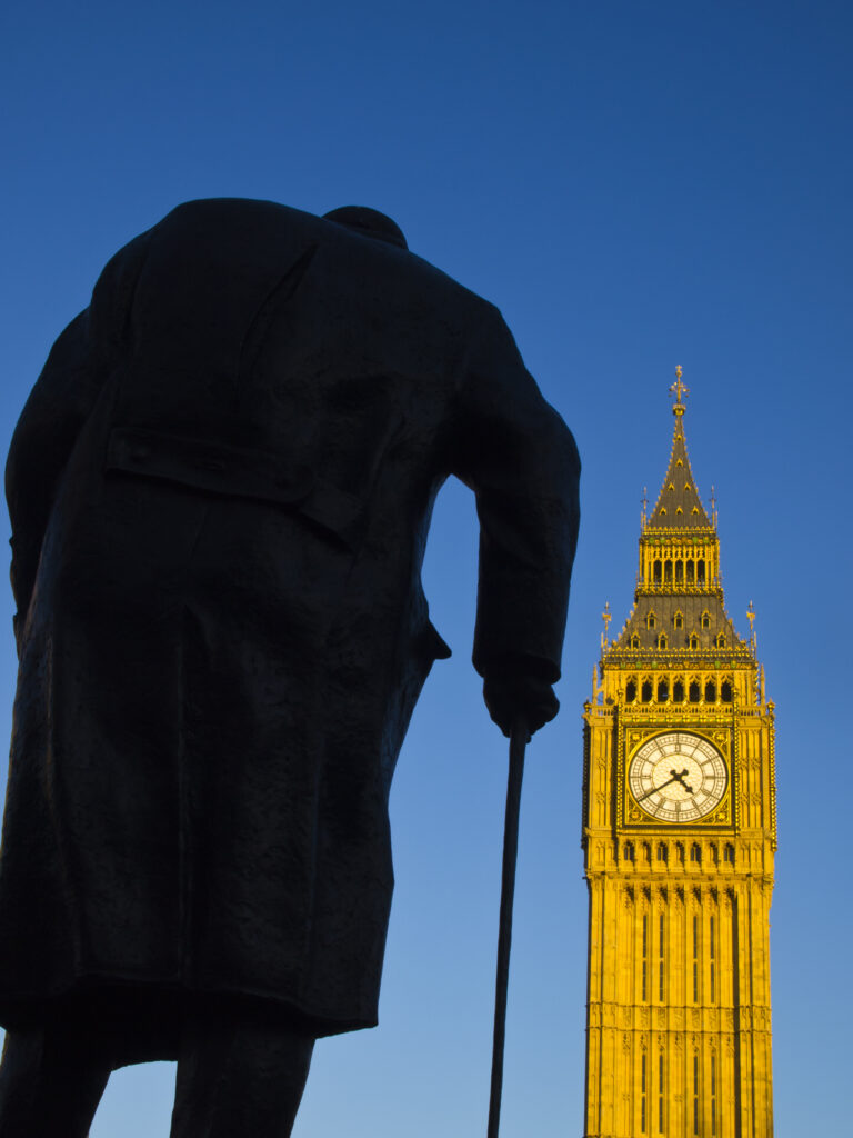 England, Greater London, City of Westminster. Churchill statue and the iconic Big Ben also known as the Clock Tower, part of the House of Parliament building (also known as the Palace of Westminster), located in the City of Westminster, London.