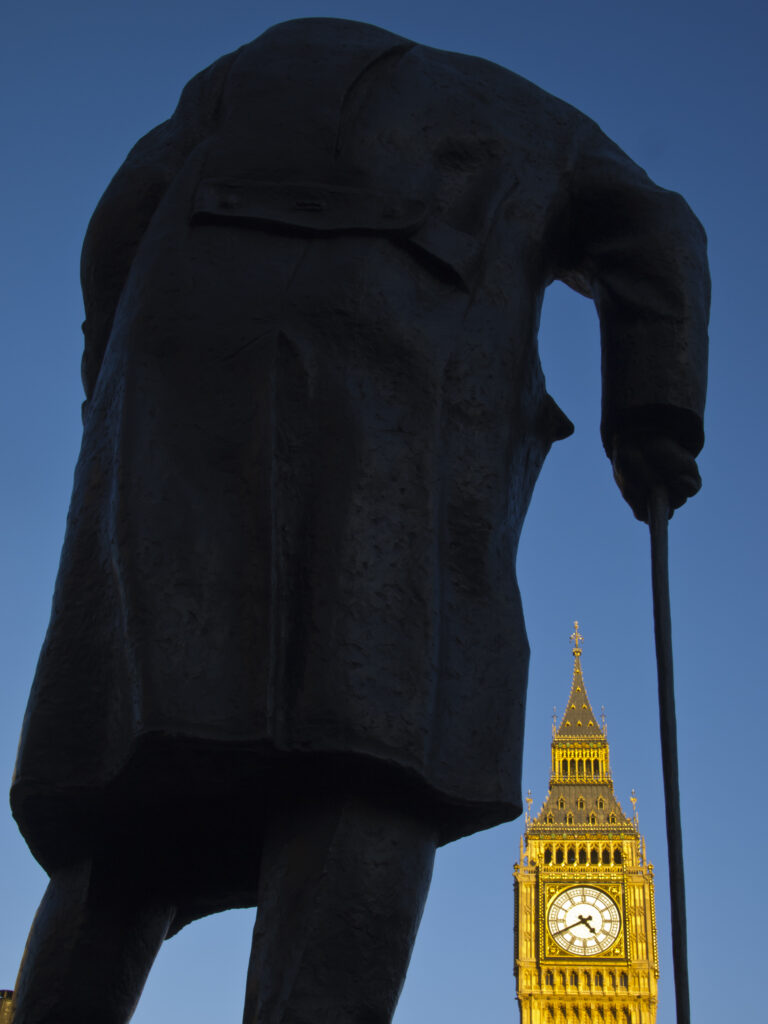 England, Greater London, City of Westminster. Churchill statue and the iconic Big Ben also known as the Clock Tower, part of the House of Parliament building (also known as the Palace of Westminster), located in the City of Westminster, London.