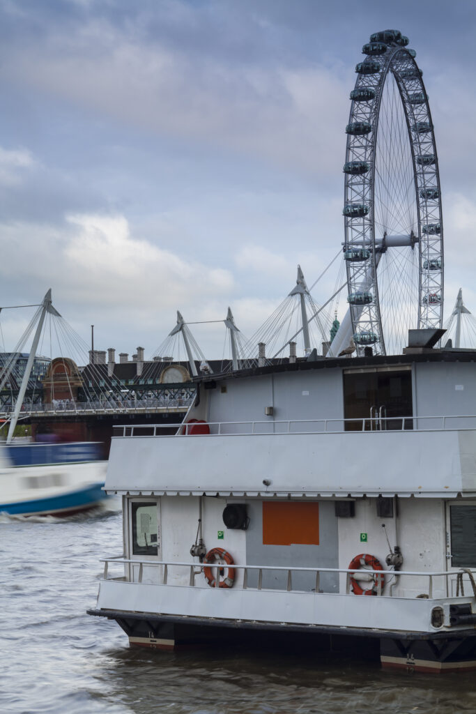 England, Greater London, London Borough of Lambeth. The London Eye (also known as the Millennium Wheel) and the Golden Jubilee Bridge on the River Thames.