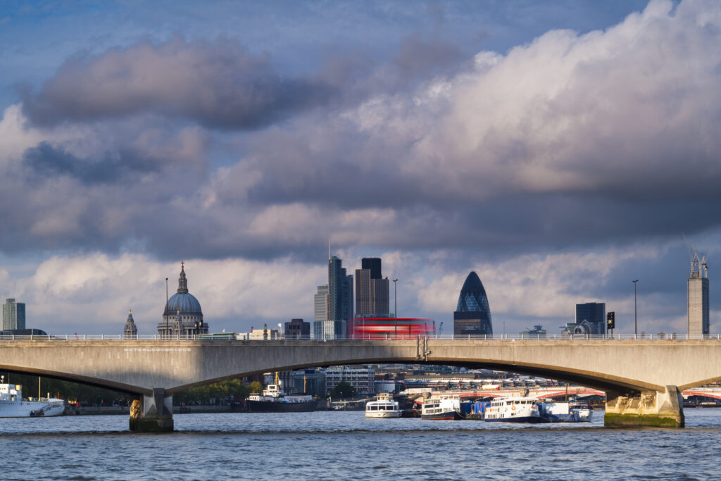 England, Greater London, London South Bank / River Thames. Waterloo Bridge, St Pauls Cathedral, the Gherkin and the financial city of london in the distance.