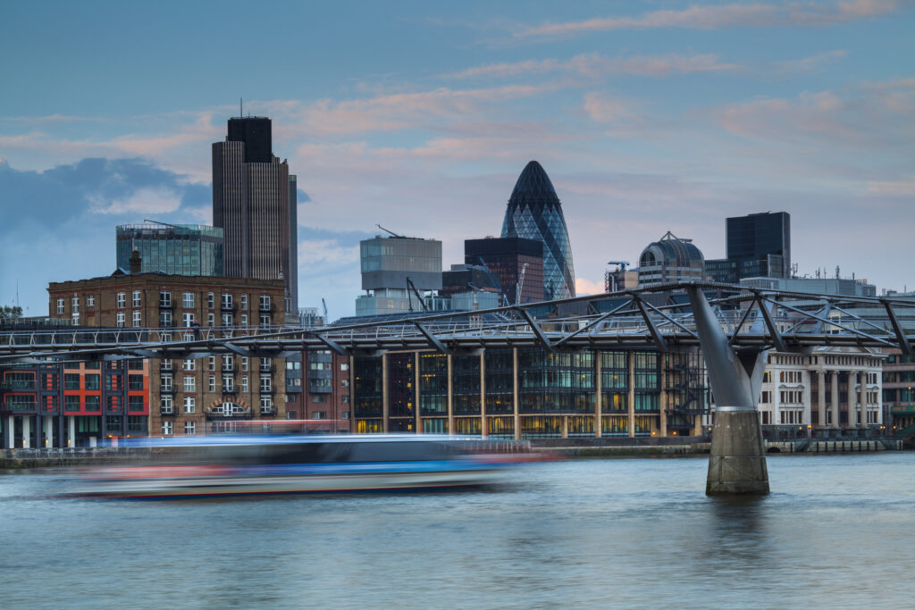 England, Greater London, London City. London City Financial District (including the Gherkin) and the London Millennium Footbridge crossing the River Thames.