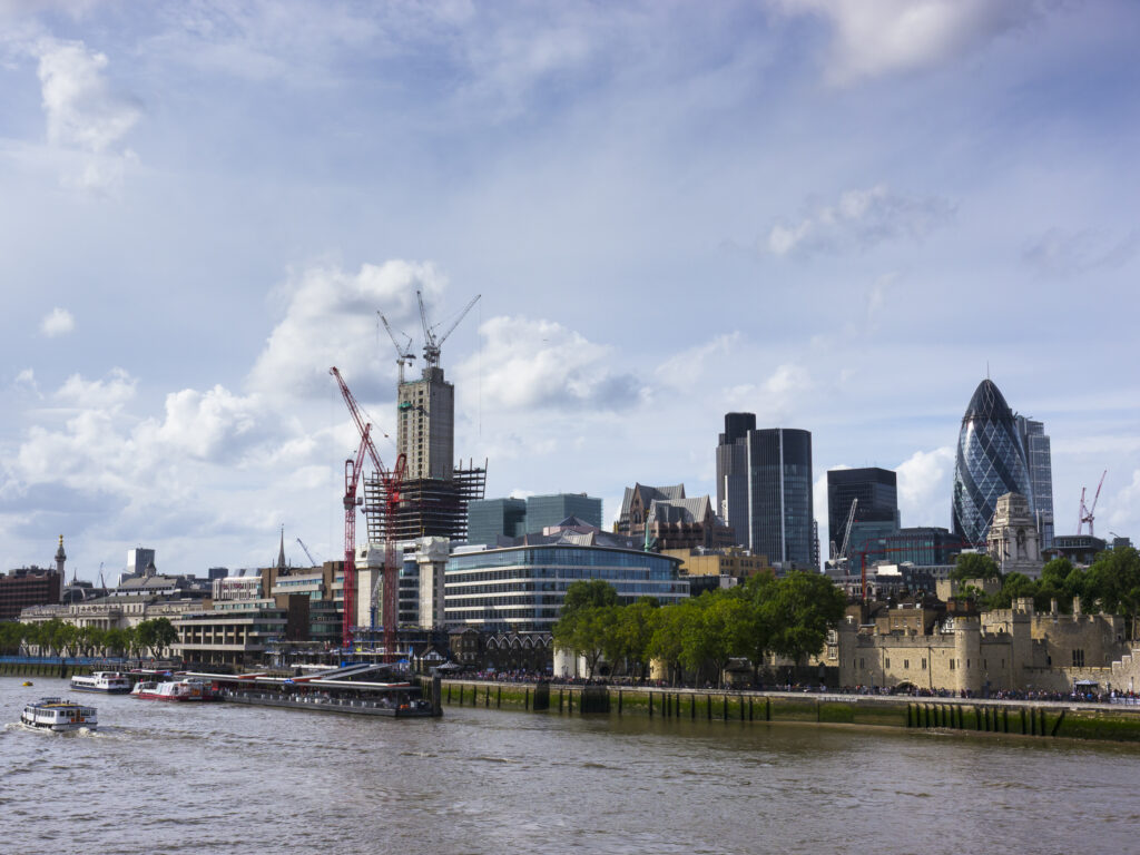 England, Greater London, London City. Construction work in the financial district of the city of London, with the iconic Gherkin building in view.