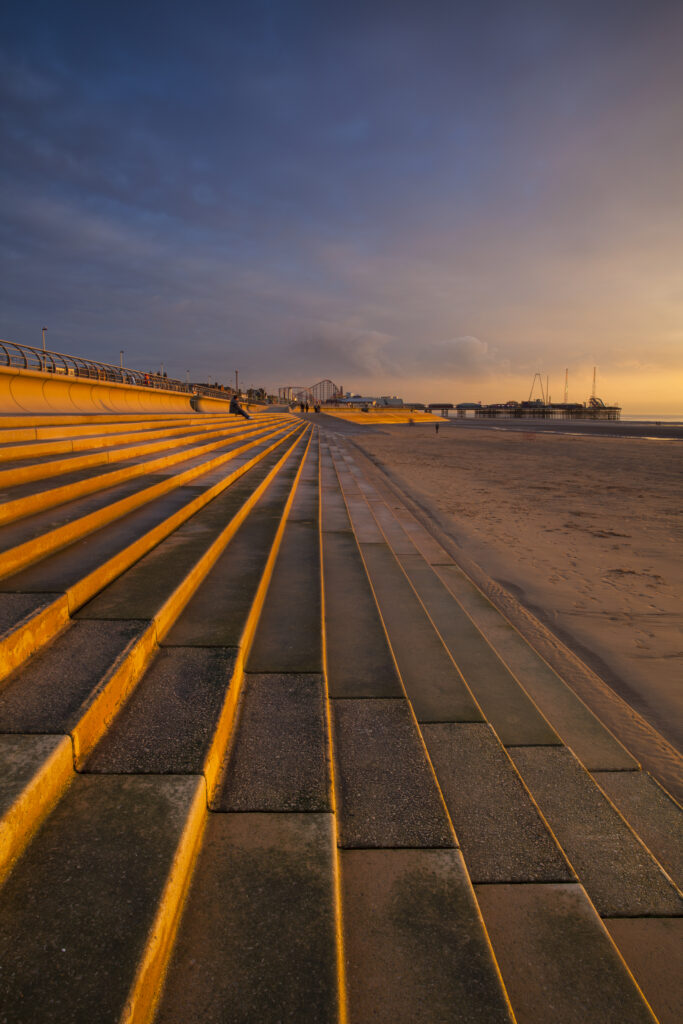 England, Lancashire, Blackpool. Blackpool Seafront Steps and Sea Defenses looking towards the South Pier and the Pleasure Beach.
