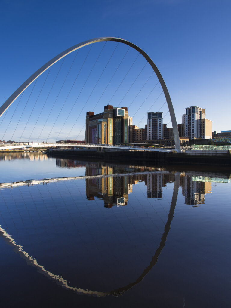 England, Tyne and Wear, Newcastle Upon Tyne. The Gateshead Millennium Bridge and Baltic Gallery on the Newcastle upon Tyne river quayside.