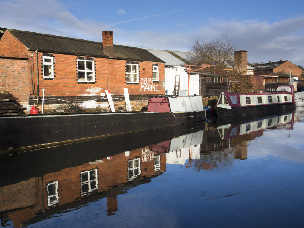 England, West Midlands, Stourbridge Canal. Narrowboats moored at Delph Marine, known locally as the boat yard, located near the Delph Nine Locks at Brierley Hill in the Black Country.