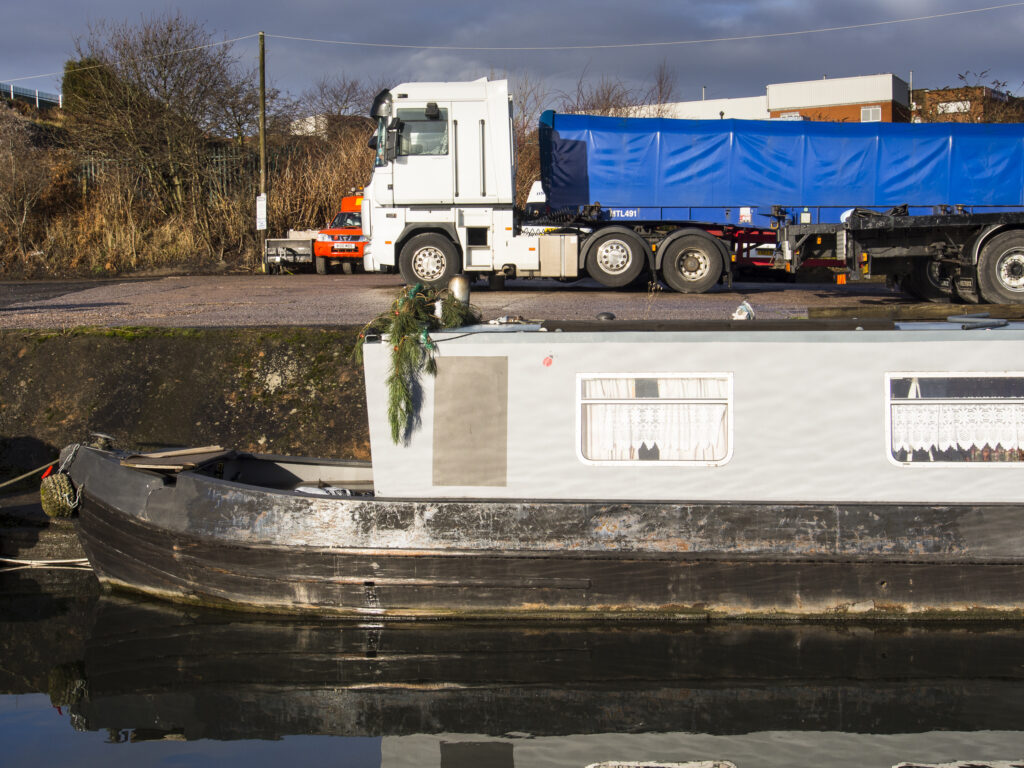England, West Midlands, Stourbridge Canal. Narrowboats moored at Delph Marine, known locally as the boat yard, located near the Delph Nine Locks at Brierley Hill in the Black Country.