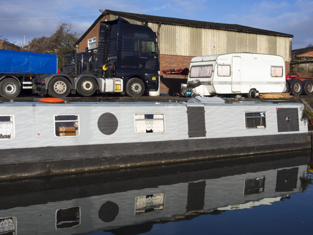 England, West Midlands, Stourbridge Canal. Narrowboats moored at Delph Marine, known locally as the boat yard, located near the Delph Nine Locks at Brierley Hill in the Black Country.