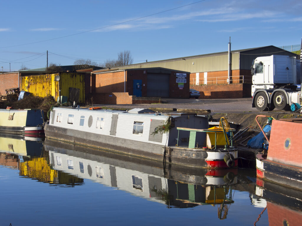 England, West Midlands, Stourbridge Canal. Narrowboats moored at Delph Marine, known locally as the boat yard, located near the Delph Nine Locks at Brierley Hill in the Black Country.