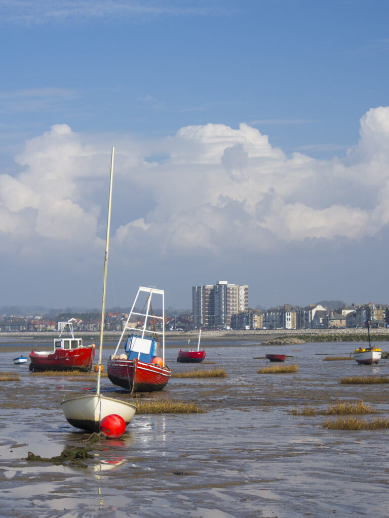 England, Lancashire, Morecambe. Fishing boats at low tide moored at Morecambe / Morecambe Bay.