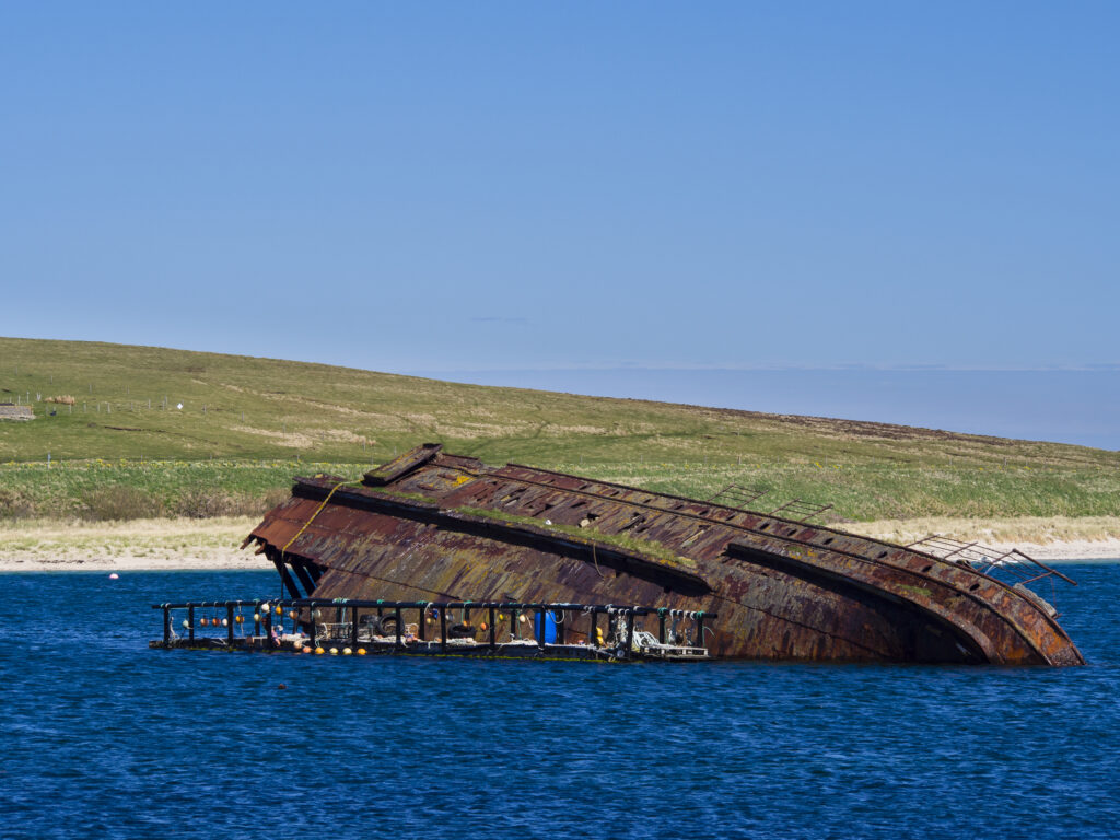 Scotland, Orkney Islands, Sunken Block Ship. Sunken Block Ship, near Churchill Barrier No. 3 linking Glimps Holm and Burray, sunk to protect the Royal Navy anchorage in Scapa Flow from German U-boats.