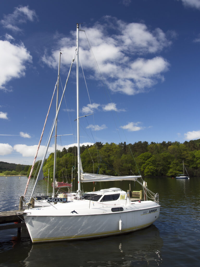 England, Cumbria, Lake District National Park. Sailing boat moored at Fell Foot Park on Lake Windermere.