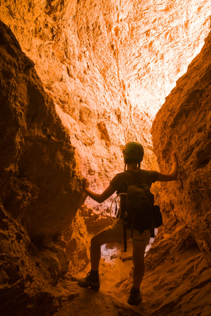 Chile, Atacama Desert, Plaza Quitor. Young woman explores the canyons in the mountains of the Atacama Desert near the Plaza Quitor.