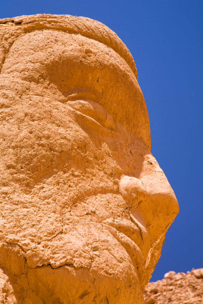 Chile, Atacama Desert, Plaza Quitor. Carved face in the stone wall of the Atacama Desert near the Plaza Quitor.