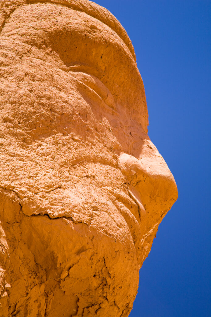 Chile, Atacama Desert, Plaza Quitor. Carved face in the stone wall of the Atacama Desert near the Plaza Quitor.