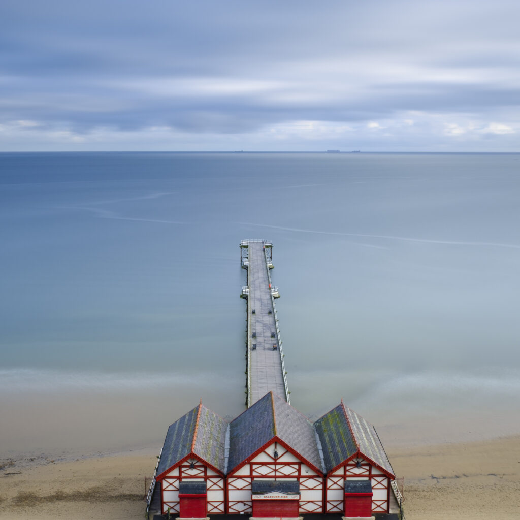 England, Cleveland, Saltburn-by-the-Sea. View from the top of the funicular railway, one of the world's oldest water-powered cliff lifts, towards the Victorian Pier and North Sea Beach.