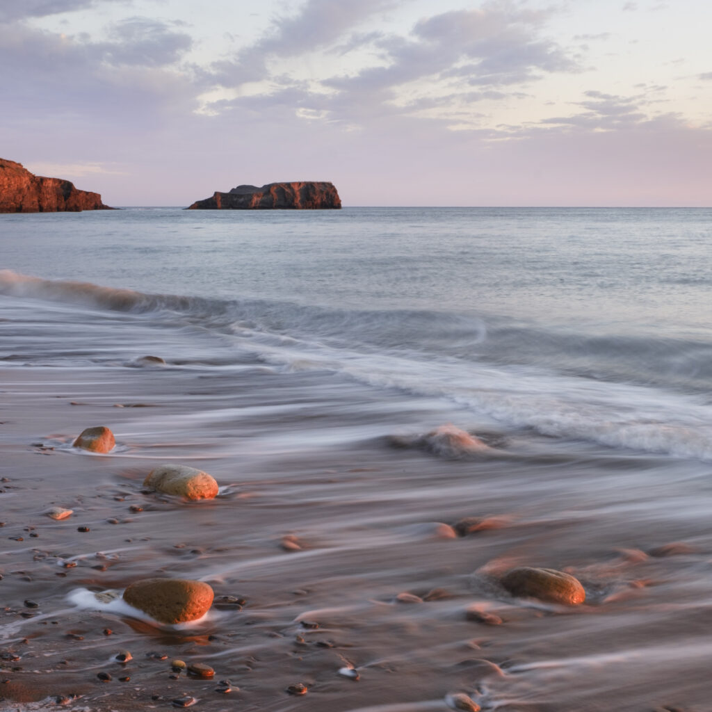 England, North Yorkshire, North York Moors National Park. Early morning light at Saltwick Bay and Nab near Whitby.