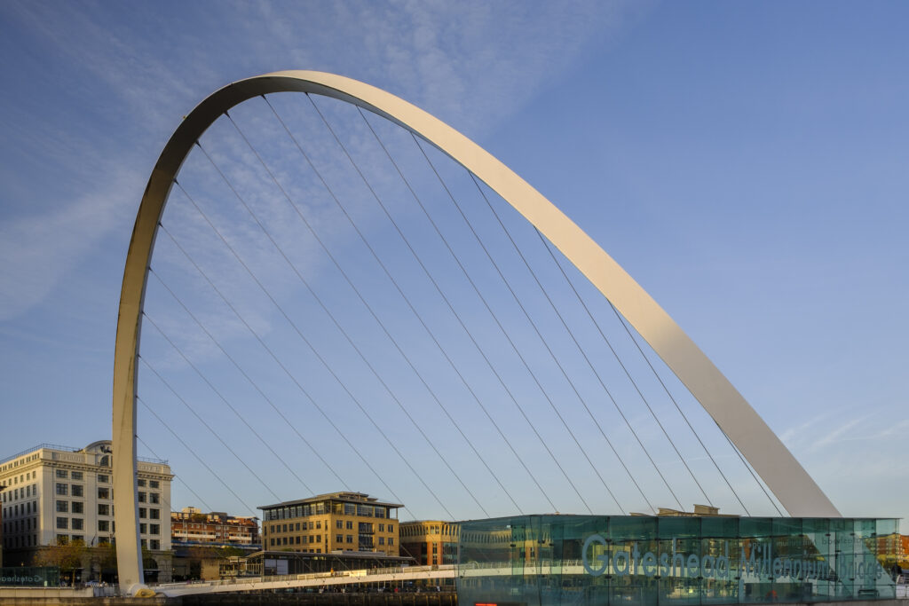England, Tyne and Wear, Gateshead Millennium Bridge. The Gateshead Millennium Bridge located alongside the River Tyne and Newcastle / Gatehead Quayside.