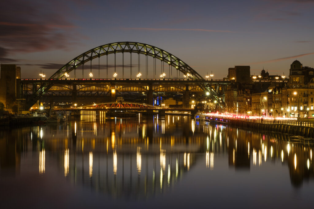 England, Tyne and Wear, Newcastle Upon Tyne. The iconic Tyne Newcastle Bridge located alongside the River Tyne and Newcastle / Gatehead Quayside.