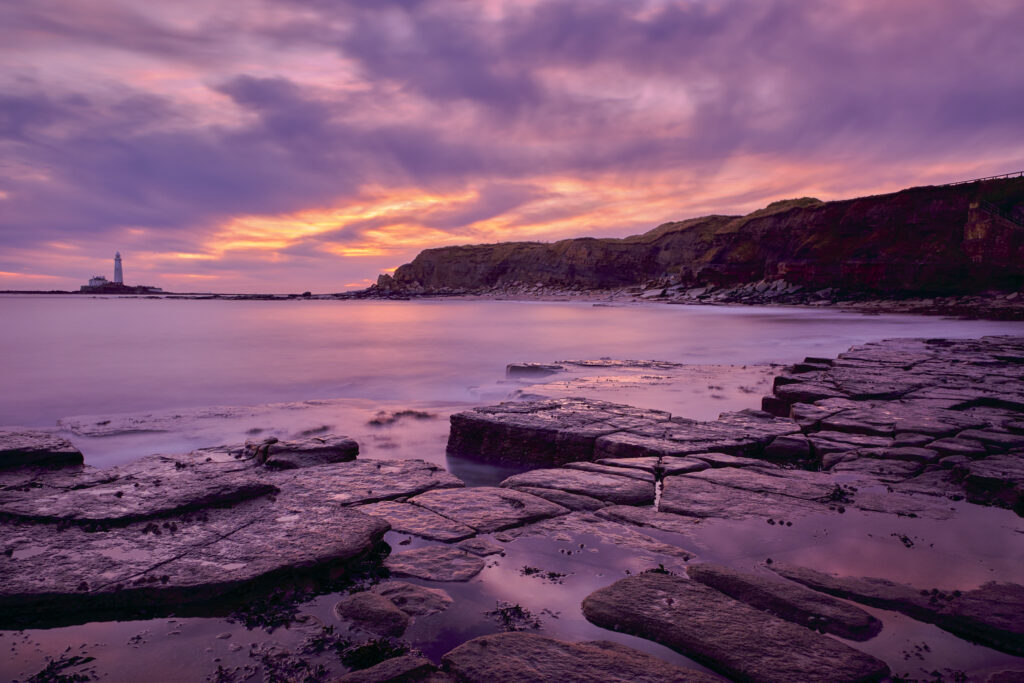 England, Northumberland, Old Hartley. Old Hartley Bay at dawn, looking towards St Mary's Lighthouse.