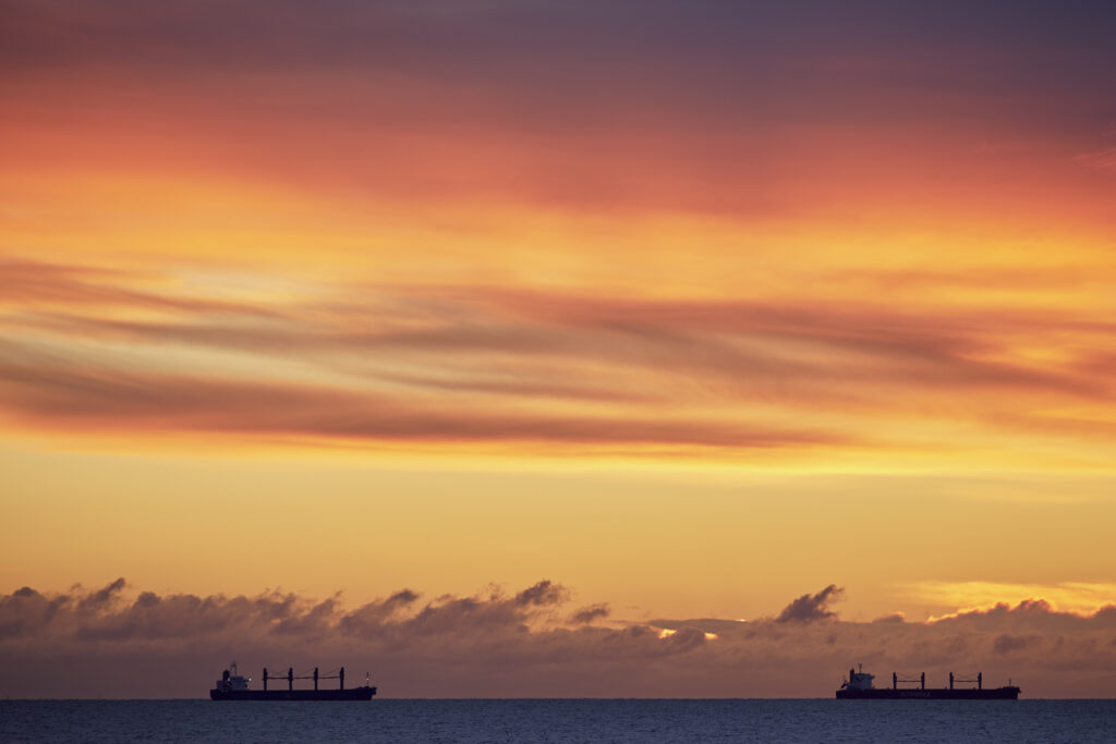 England, Tyne and Wear, Whitley Bay. Boats on the North Sea viewed at dawn.