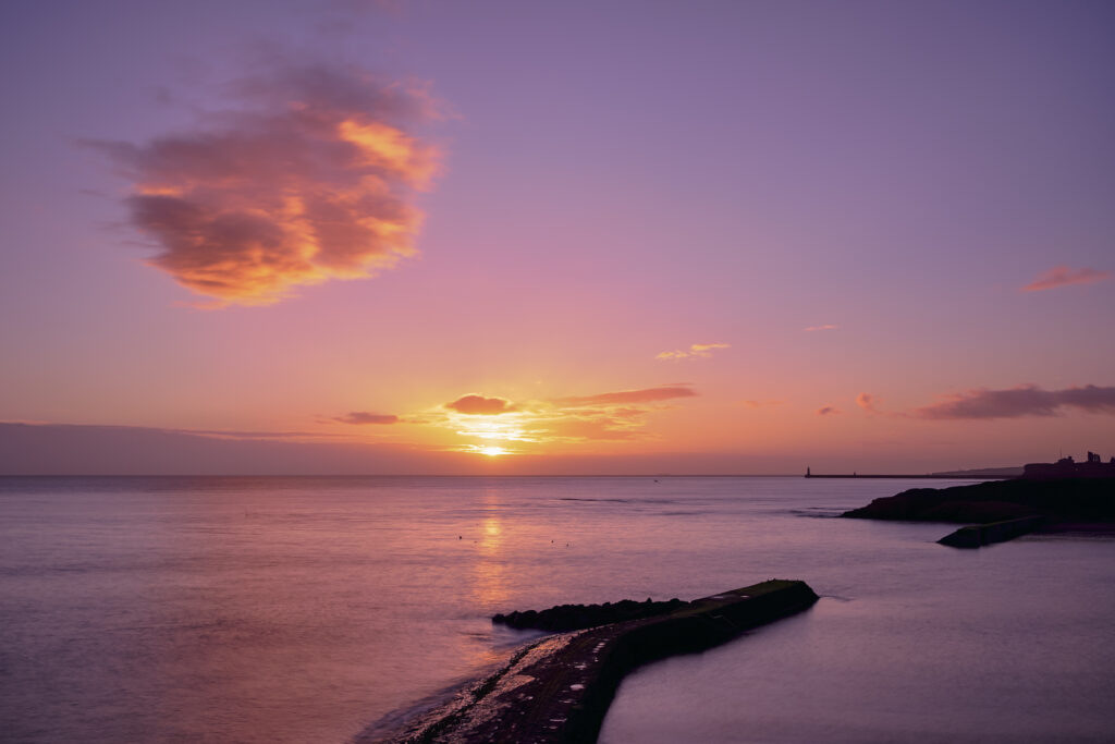 England, Tyne and Wear, Cullercoats. Sunrise over Cullercoats Bay.