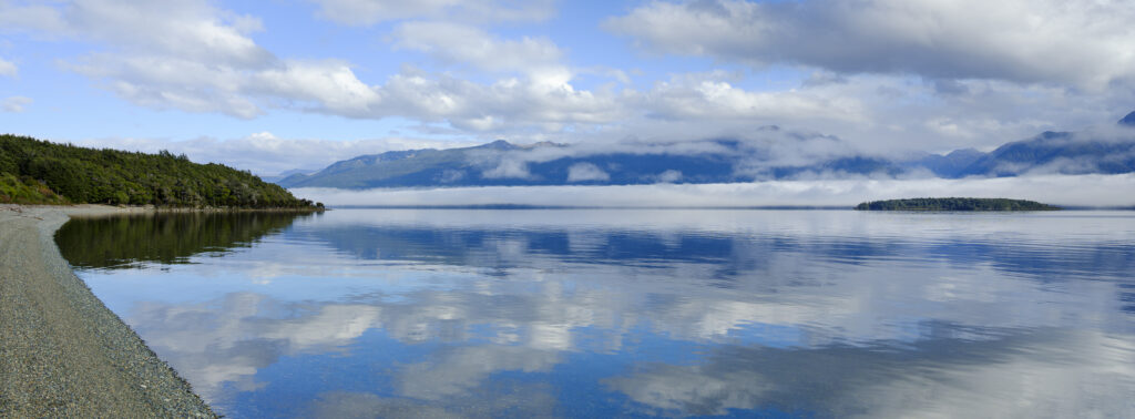 New Zealand, South Island, Fiordland National Park. Morning mist at Fiordland National Park, viewed from the shores of Lake Te Anau.