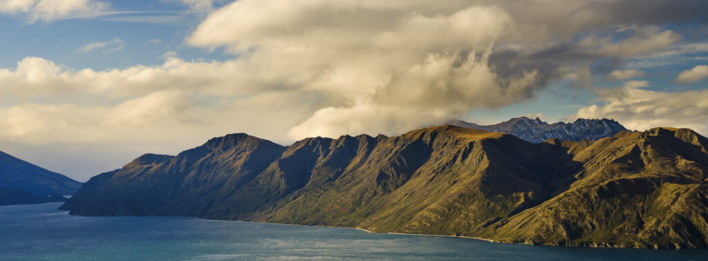 New Zealand, South Island, Mount Aspiring National Park. Late afternoon light on Lake Wanaka and Mount Aspiring National Park.