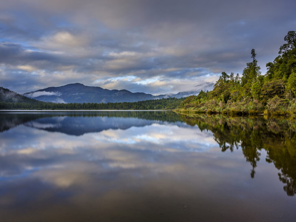 New Zealand, West Coast, Lake Paringa. Dusk at Lake Paringa in the Te Wāhipounamu South West New Zealand World Heritage Area.