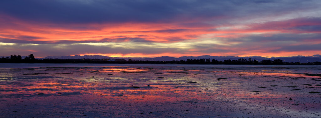 New Zealand, Christchurch, New South Brighton. A colourful sunset above the Avon Heathcote Estuary in Christchurch.
